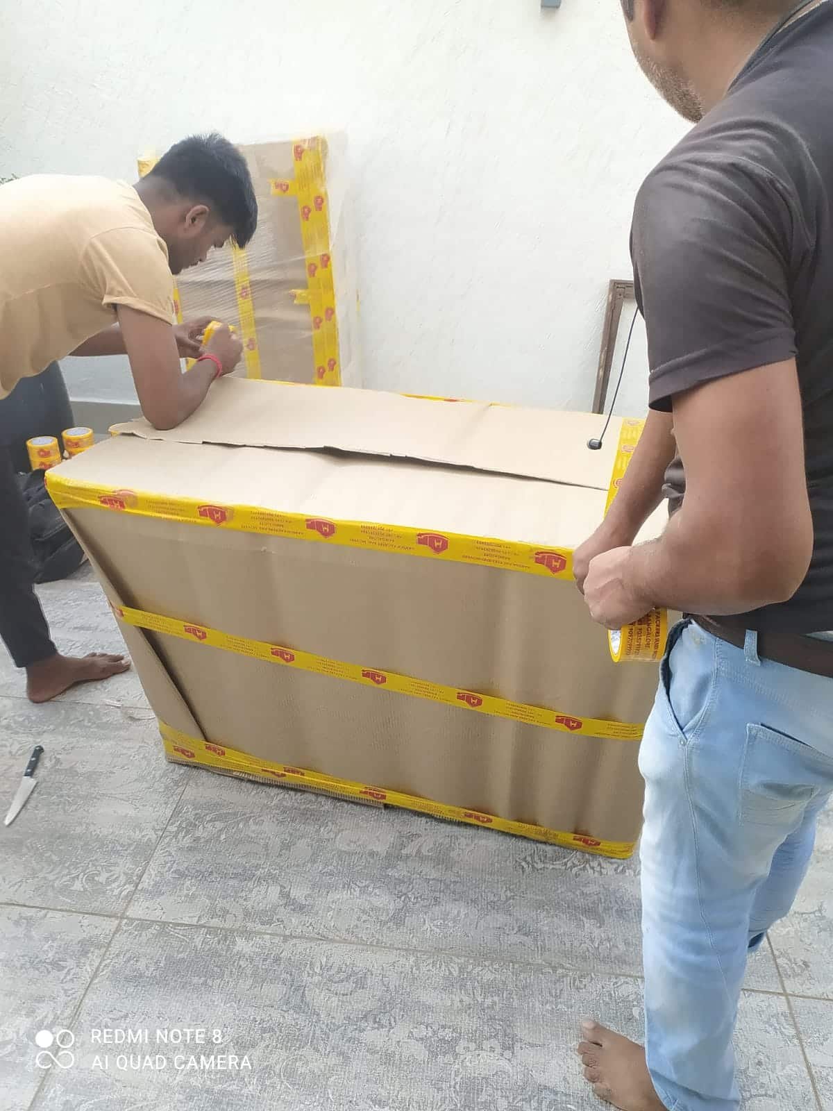 Domestic Shifting Services in Bangalore – Professional Packing Team Two professional packers packing household items for domestic shifting service in Bangalore